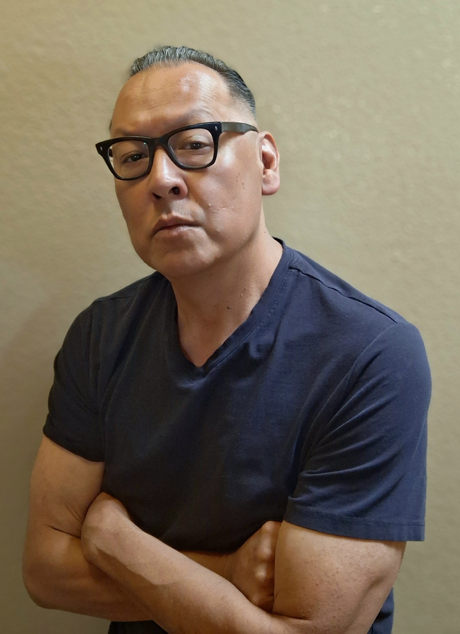 Front view of a man with a fresh haircut and glasses