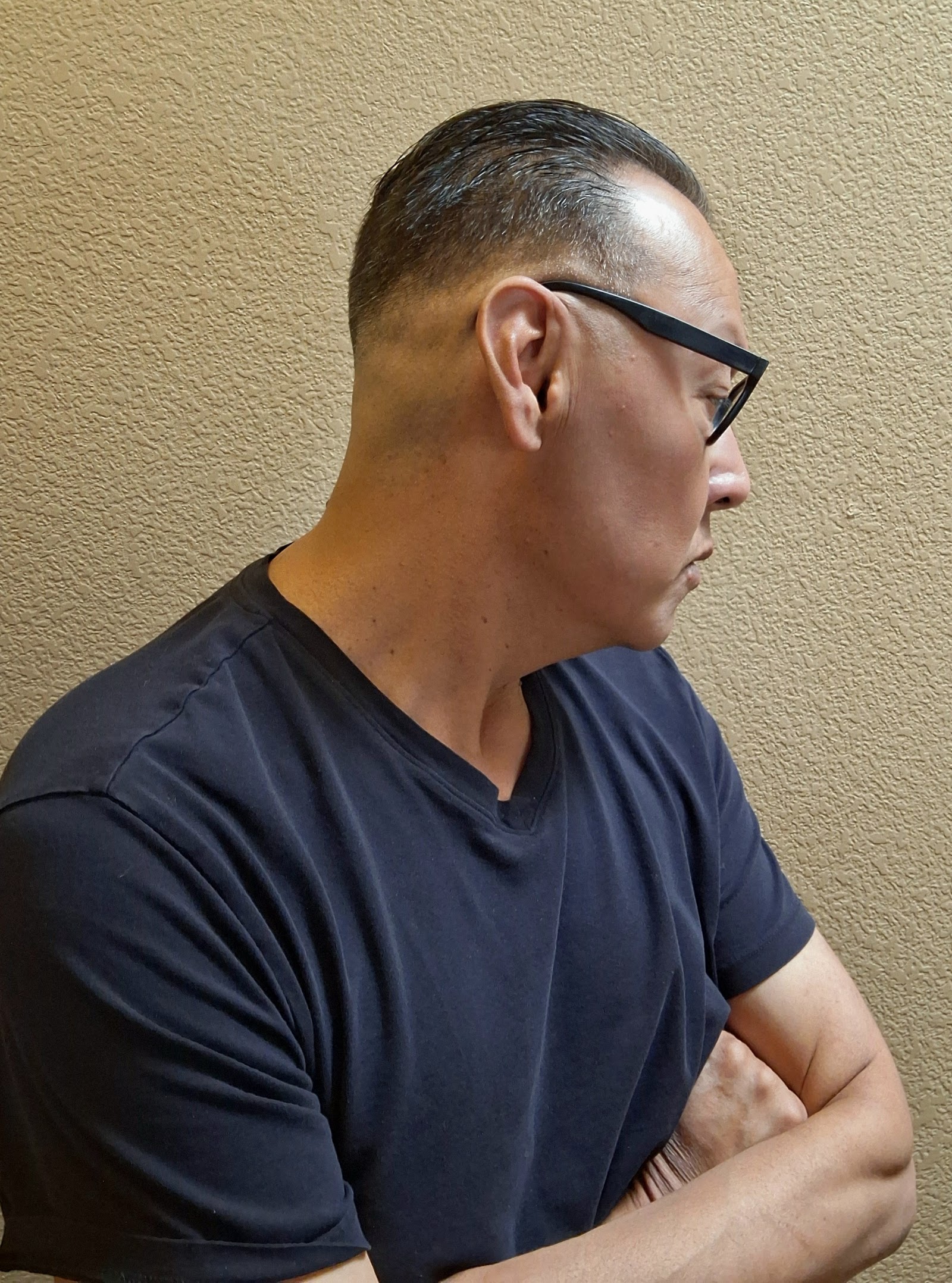 Side profile showing a clean fade and tapered sides